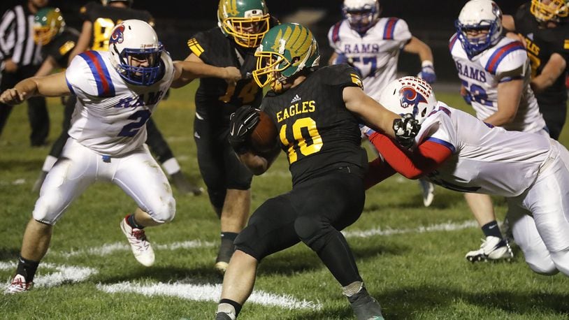 Madison-Plains’ Jacob Toops gets tackled by Greeneview’s Jacob Green, left, and Bryce Da. BILL LACKEY / STAFF