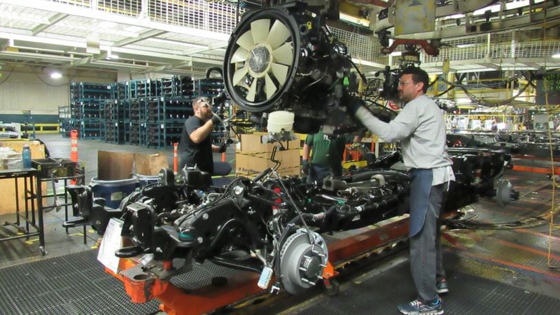 Workers at Moraine-based DMAX, working on Duramax diesel engines. CONTRIBUTED