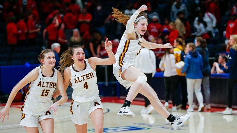 Alter High School senior Caraline Kernan jumps in celebration with teammates Emma Hansley (4) and Riley Smith (12) after their team beat Columbus Bishop Hartley 69-33 on Thursday night at UD Arena to advance to Saturday's Division II state championship game against Thornville Sheridan. CONTRIBUTED PHOTO BY MICHAEL COOPER