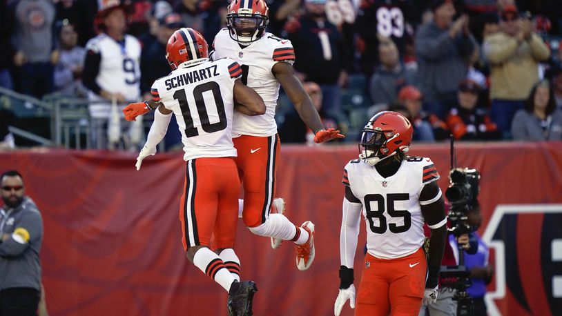 Cleveland Browns' Donovan Peoples-Jones (11) celebrates a touchdown reception with Anthony Schwartz (10) and David Njoku (85) during the first half of an NFL football game against the Cincinnati Bengals, Sunday, Nov. 7, 2021, in Cincinnati. (AP Photo/Bryan Woolston)