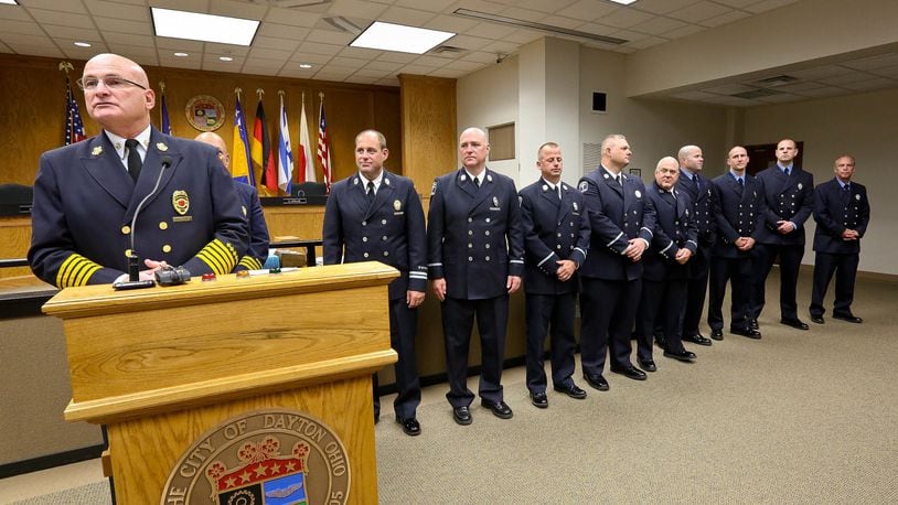 L-R: The Dayton Fire Department promoted nine public safety professionals to new ranks at a ceremony Friday in the City Commission Chambers. Elected officials and firefighter family members were in attendance. Presiding at the podium is Director and Chief Jeff Payne. LEf to Right: Paul A. Raisch was promoted to District Chief; promoted to the rank of Captain are Christopher J. Kinzeler, Robert M. Barnes, Gregory Patterson, Steven J. Holten; being promoted to the rank of Lieutenant are Jarod J. Meyer, Matthew J. Quick, Jr., Matthew W. Sherrill, and Steven Jenson. JIM WITMER/STAFF