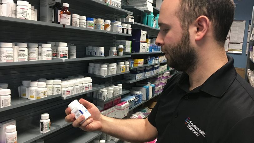 Pharmacist Phil Pauvlinch works at the Equitas Health Pharmacy in Dayton, formerly AIDS Resource Center Ohio. Hepatitis C and HIV patients who get pharmacy benefits through Medicare Part D are being hit hard by rising out-of-pocket costs. KATIE WEDELL/STAFF