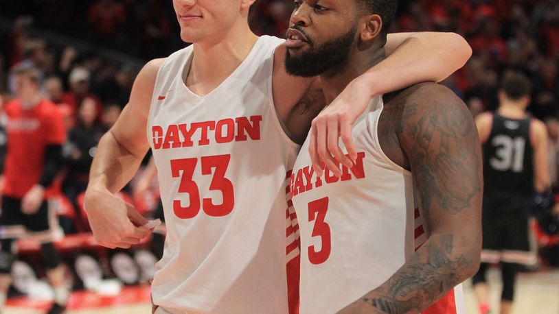 Dayton’s Ryan Mikesell and Trey Landers leave the court after a victory against Davidson on Friday, Feb. 28, 2020, at UD Arena. David Jablonski/Staff