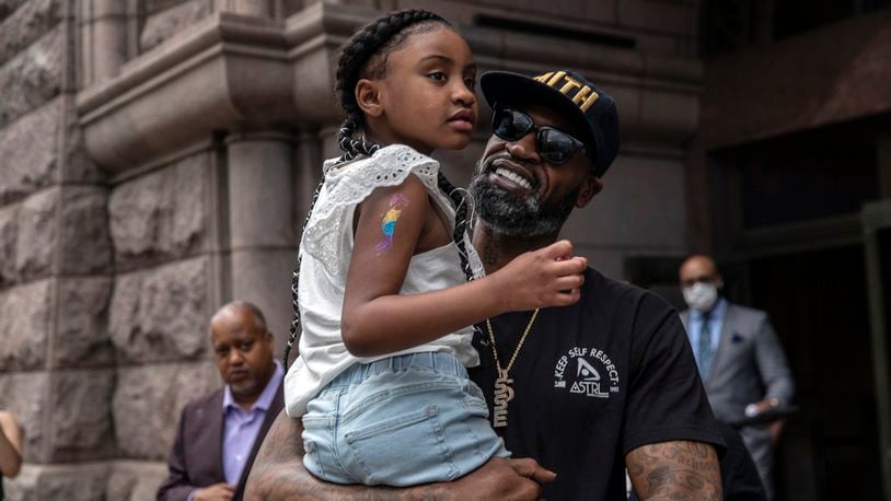 FILE -- Former professional basketball player Stephen Jackson holds Gianna Floyd, 6, daughter of George Floyd, at a news conference in Minneapolis on Tuesday, June 2, 2020. Those who knew Jackson during his 14-year NBA career are not surprised at how he has worked tirelessly as an activist in support of his friend George Floyd.