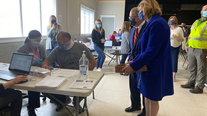 Ohio Gov. Mike DeWine and Ohio First Lady Fran DeWine (right) look on as Barry Gertner, 54, gets a COVID-19 vaccine at a vaccination clinic in Piqua on Saturday, March 27, 2021. EILEEN McCLORY / STAFF
