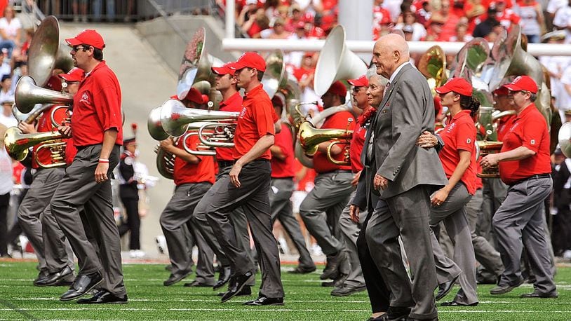 COLUMBUS, OH - SEPTEMBER 05: Former U.S. Senator John Glenn (D-OH) and his wife Annie Glenn walk off the field after dotting the ‘i’ as the Ohio State Alumni Marching Band forms script Ohio during halftime of a game against the Navy Midshipmen at Ohio Stadium on September 5, 2009 in Columbus, Ohio. (Photo by Jamie Sabau/Getty Images)