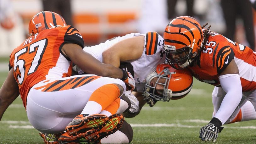 CINCINNATI, OH - NOVEMBER 17:  Vontaze Burfict #55 and Vincent Rey #57 of the Cincinnati Bengals tackle Jordan Cameron #84 of the Cleveland Browns during their game at Paul Brown Stadium on November 17, 2013 in Cincinnati, Ohio.  The Bengals defeated the Browns 41-20.  (Photo by John Grieshop/Getty Images)