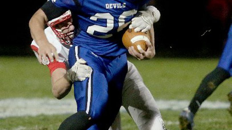 Bailey Wallen (with ball) led Brookville over Carlisle 41-0 in a D-V first-round playoff game last season. EL HUBBARD PHOTO