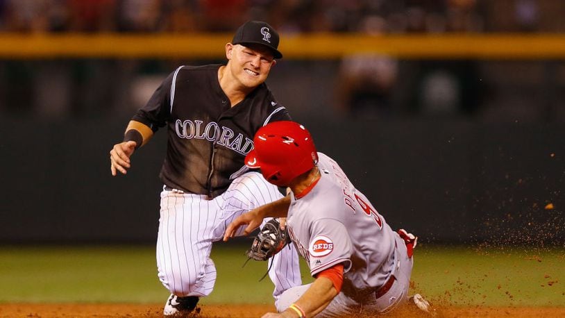 DENVER, CO - JULY 5:  Pat Valaika #4 of the Colorado Rockies applies the tag to catch Jose Peraza #9 of the Cincinnati Reds in an attempt to steal second base to end the eighth inning at Coors Field on July 5, 2017 in Denver, Colorado. The Rockies defeated the Reds 5-3. (Photo by Justin Edmonds/Getty Images)