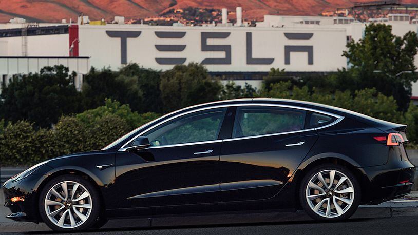 This image provided by Tesla Motors shows the Tesla Model 3 sedan. Electric automaker Tesla has produced its first Model 3 sedan, a highly anticipated car because it carries a relatively low sticker price. On Saturday, July 8, 2017, CEO Elon Musk tweeted pictures of the car, which will cost $35,000 and can travel 215 miles on a single electric charge. A $7,500 federal tax credit for electric vehicles would lower the cost to $27,500. (Courtesy of Tesla Motors via AP)