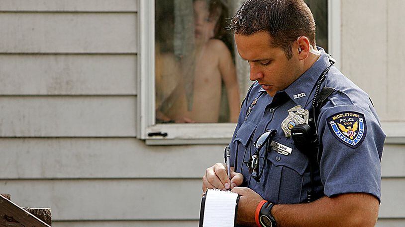 Middletown patrol officer Phil Salm checks on the wellbeing of children in a west Middletown neighborhood in 2006. Photo by Jim Noelker
