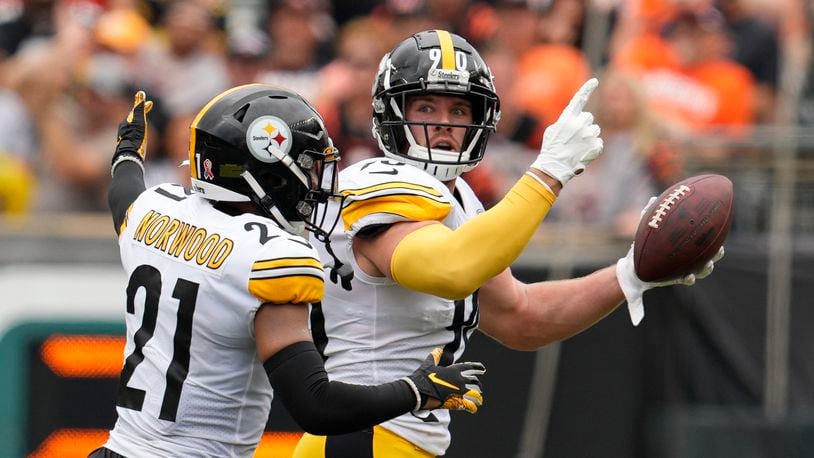 Pittsburgh Steelers linebacker T.J. Watt (90) celebrates after an interception with safety Tre Norwood (21) during the first half of an NFL football game against the Cincinnati Bengals, Sunday, Sept. 11, 2022, in Cincinnati. (AP Photo/Jeff Dean)