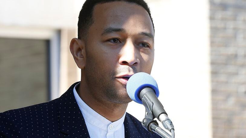 John Legend speaks to the crowd before cutting the ribbon for the new John Legend Theater in Springfield. Bill Lackey/Staff