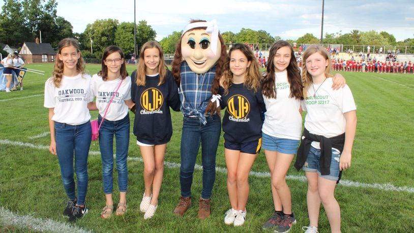 Brigid Newman, Clare Newman, Anna Newman , Principal Paul Waller, Ashlyn Steinbrink, Natalia Rubin-Alvarez and Lena Gaskin pose with “Jill,” the new mascot created by members of Oakwood Girl Scout Troup 32317 in order to bring a female mascot to represent the girls sports teams at Oakwood schools.