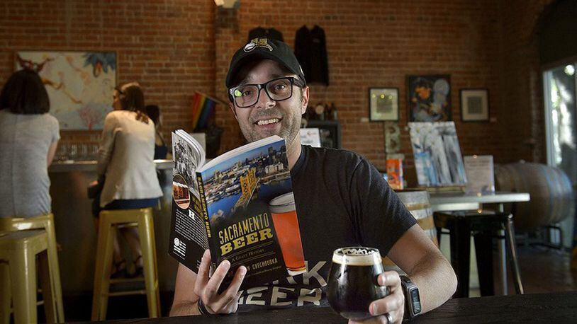 Author of the new book "Sacramento Beer: A Craft History" Justin Chechourka enjoys a glass of beer at Big Stump brewery in Sacramento, Calif. on Friday, May 4, 2018. (Randall Benton/Sacramento Bee/TNS)