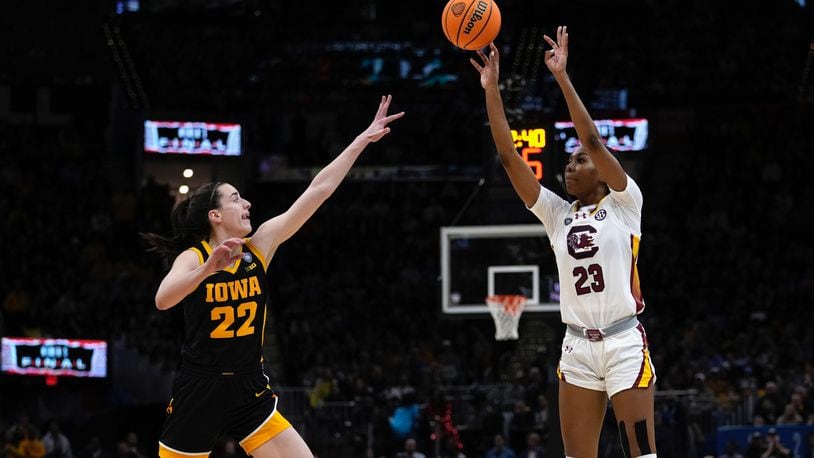 South Carolina guard Bree Hall (23) shoots over Iowa guard Caitlin Clark (22) during the second half of the Final Four college basketball championship game in the women's NCAA Tournament, Sunday, April 7, 2024, in Cleveland. (AP Photo/Carolyn Kaster)
