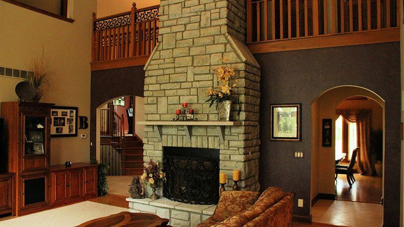 A wide archway leads into the great room with an eye-catching stone fireplace.