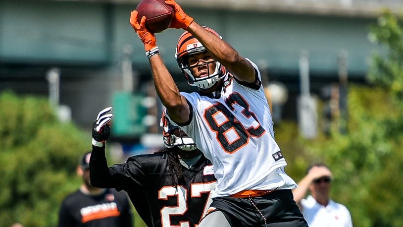 Wide receiver Tyler Boyd makes a jumping catch defended by Dre Kirkpatrick during the first day of Cincinnati Bengals Training Camp Friday, July 28 at the practice fields beside Paul Brown Stadium in Cincinnati. NICK GRAHAM/STAFF
