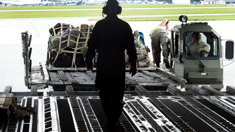 A Wright-Patterson based Air Force Reserve crew loads luggage at Joint Base McGuire-Dix-Lakehurst in New Jersey after picking up troops and supplies to deliver to Florida to assist with Hurricane Irma recovery efforts in September 2017. BOB GARLOCK / STAFF