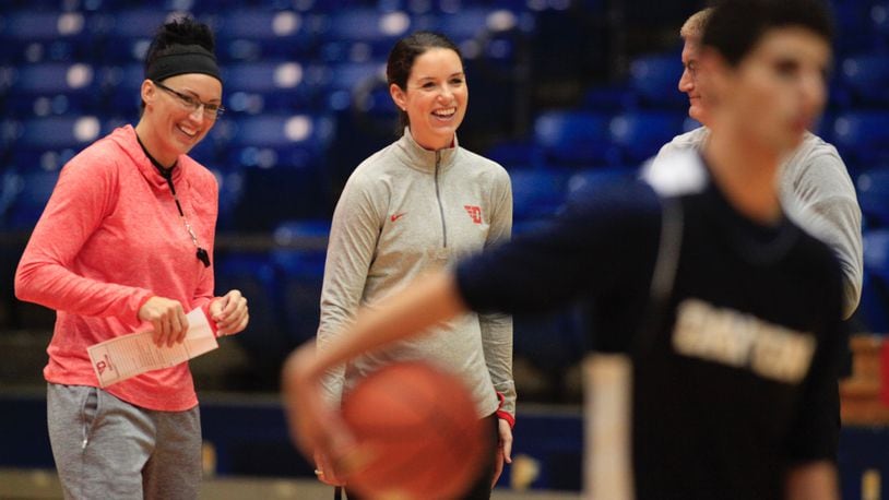 Dayton coaches Kayla Ard, left, Shauna Green, center, and Jeff House, back right, watch practice at UD Arena on Tuesday, Oct. 11, 2016. David Jablonski/Staff