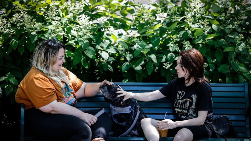 Emma Mills, left and Drake Haworth along with their dog, Salem, enjoy a warm Spring day at Riverscape Metro Park. JIM NOELKER/STAFF