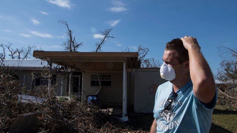 James Filley looks out over the damage to his home on Oct. 17, 2018, at Tyndall Air Force Base, Florida, after returning to the base for the first time since Hurricane Michael struck the base one week before. Support personnel from Tyndall and other bases were on location to support Airmen returning to their homes to assess damage and collect personal belongings.(U.S. Air Force photo/Airman 1st Class Kelly Walker)