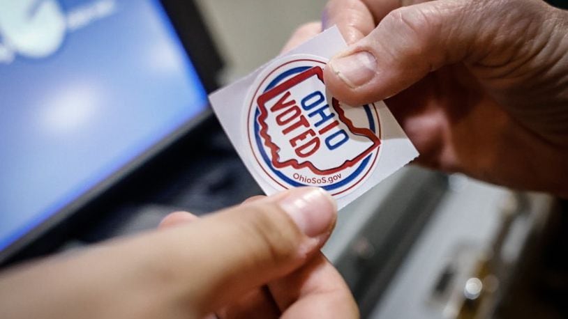 A voter receives a sticker for voting at St. Leonard. Jim Noelker/Staff