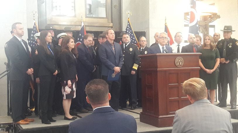 Gov. Mike DeWine and other state officials, backed by members of law enforcement, announce his support for a bill that would direct $250 million in federal funding to grant programs for first responders.