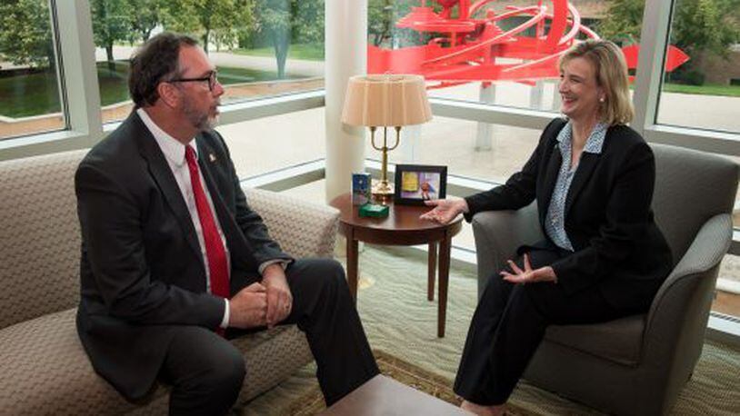 WSU’s Cheryl Schrader meets in her office with Sinclair Community College president Steve Johnson.