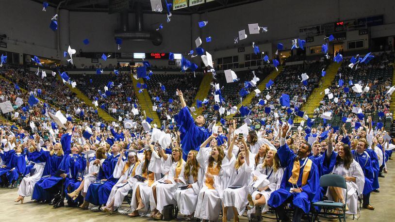 Springboro grads celebrate their emancipation by throwing their caps upward at the Nutter Center in Fairborn this past May 26. CONTRIBUTED
