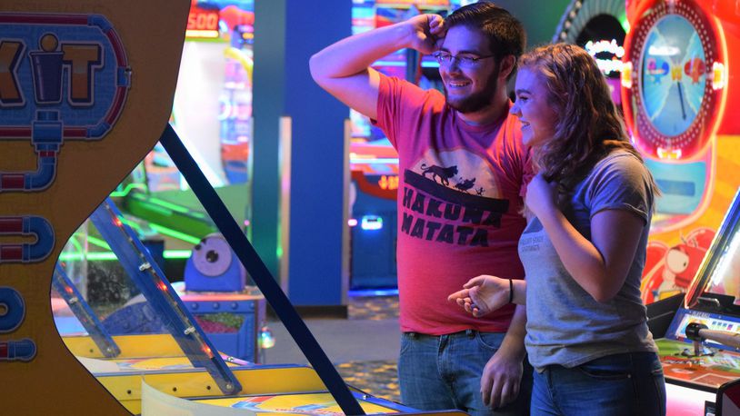 Kylie Salamon and Rett Genatempo play an arcade game at the New Round1 in the Mall at Fairfield Commons Saturday during an exclusive soft opening. This is the second Ohio location filling the lower floor of a vacant Sears. STAFF PHOTO / HOLLY SHIVELY