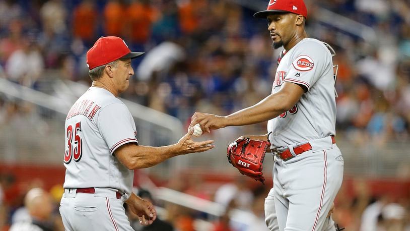 MIAMI, FL - SEPTEMBER 22:  Relief pitcher Amir Garrett #50 of the Cincinnati Reds gives the ball to interim manager Jim Riggleman #35 in the sixth inning of play against the Miami Marlins at Marlins Park on September 22, 2018 in Miami, Florida. (Photo by Joe Skipper/Getty Images)