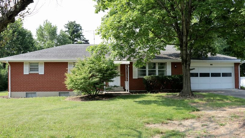 Sliding patio doors off the family room open out to a covered concrete patio. The house sits on nearly a half-acre property. The brick ranch has three bedrooms and two full bathrooms and a full, semi-finished basement. Kathy Tyler/CONTRIBUTED