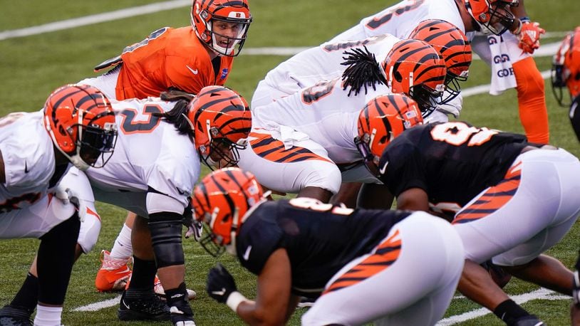 Cincinnati Bengals quarterback Joe Burrow (9) lines up under center during an NFL football team scrimmage in Cincinnati, Sunday, Aug. 30, 2020. (AP Photo/Bryan Woolston)