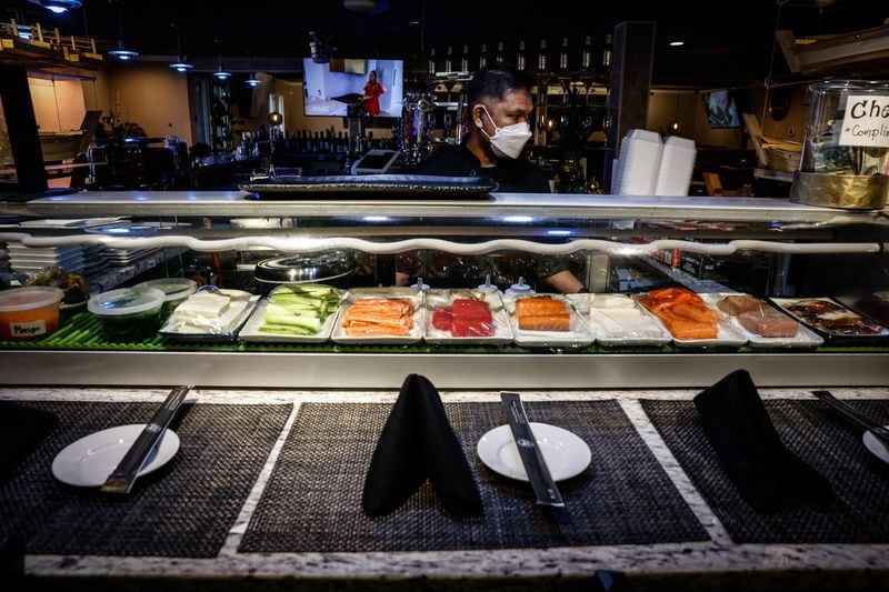 Thai Table Sushi chef Art Sabsombat prepares food at the restaurant Monday, March 14, 2022. Two years ago, Ohio closed indoor bars and restaurants for two and a half months in hopes of stop the spread of COVID-19.  JIM NOELKER/STAFF