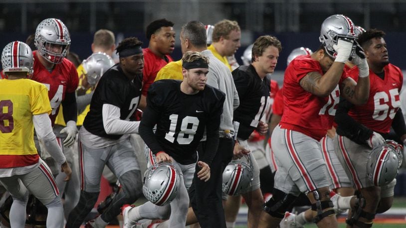 Ohio State players, including Tate Martell (18), break a huddle during practice at AT&T Stadium on Tuesday, Dec. 26, 2017, in Arlington, Texas. David Jablonski/Staff