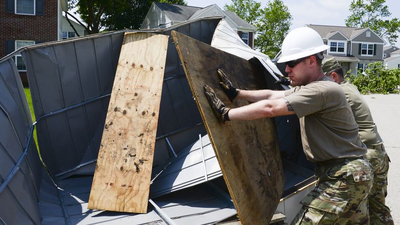 Staff Sgt. Michael Olson, National Air and Space Intelligence Center, helps to remove a shed from the front yard of someone’s home during recovery operations. Residents worked alongside other volunteers from around Wright-Patterson AFB and base emergency responders to ensure everyone’s safety and begin the cleanup process. (U.S. Air Force photo by R.J. Oriez)