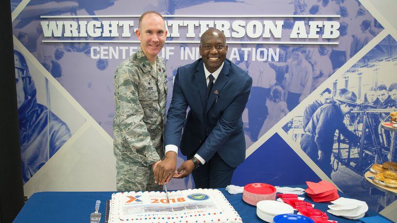 Col. Leonard T. Rose, 88th Mission Support Group commander, and Jermaine Wilson, Wright-Patterson Exchange general manager, cut a commerative cake at the Exchange’s grand re-opening ceremony Oct. 25. The event culminated a $6.4 million renovation for the nearly 40-year-old facility, which was last remodeled in 2010. (U.S. Air Force photo/John Harrington)