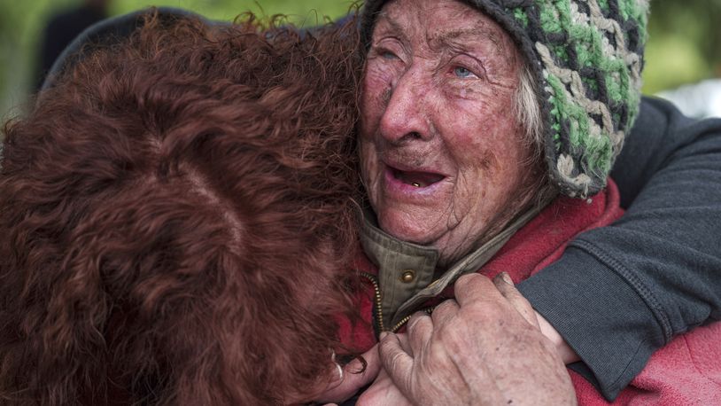 Tetiana, 82, cries with her daughter as she is evacuated from Vovchansk, Ukraine, Saturday, May 11, 2024. Her husband was killed in their house after a Russian airstrike on the city. (AP Photo/Evgeniy Maloletka)