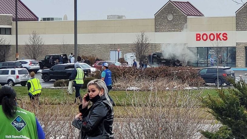 A vehicle went across a road and parking lot and into the Books store in the Washington Park shopping center. The vehicle landed on its side and briefly was on fire. DARIUS BABCOCK/STAFF