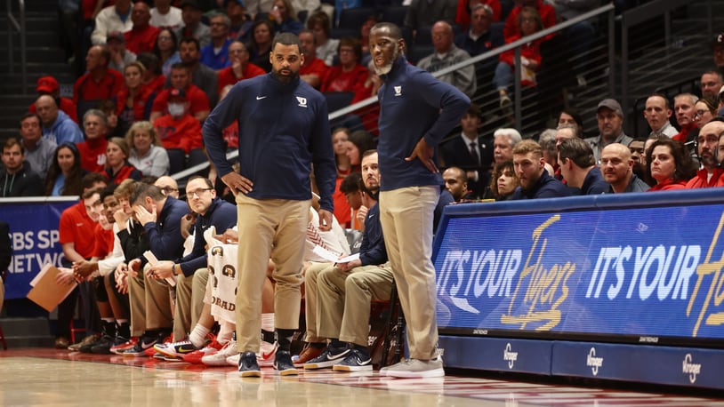 Dayton's Anthony Grant, right, and Ricardo Greer coach during a game against Davidson on Tuesday, Jan. 17, 2023, at UD Arena. David Jablonski/Staff