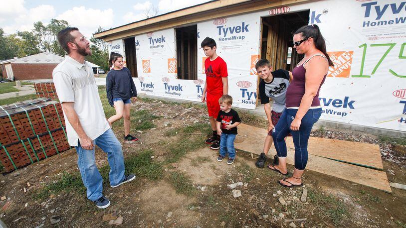 Gloria and Kevin Pennington spent harrowing minutes with their children Noah, 13, 10-year-old twins, Ayden and Alyson, and Owen, 2, as the EF4 Memorial Day tornado took apart their Brookville home. They are among survivors rebuilding in Terrace Park. CHRIS STEWART / STAFF