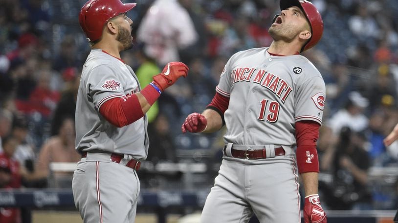 SAN DIEGO, CA - APRIL 18: Joey Votto #19 of the Cincinnati Reds celebrates with Eugenio Suarez #7 after hitting a solo home run during the first inning of a baseball game against the San Diego Padres at Petco Park April 18, 2019 in San Diego, California.  (Photo by Denis Poroy/Getty Images)