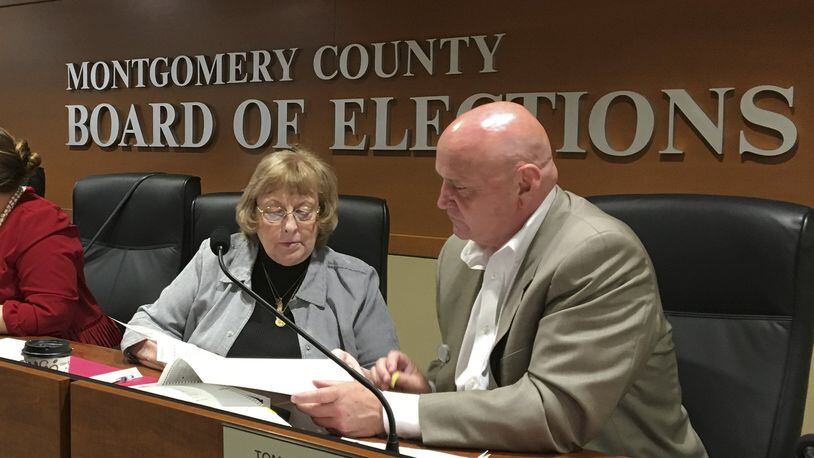 Montgomery County Board of Elections members Kay Wick and Tom Young review absentee ballots that were damaged or the voter’s intent was not immediately clear. More voters will cast ballots in person Tuesday during the primary election. CHRIS STEWART / STAFF