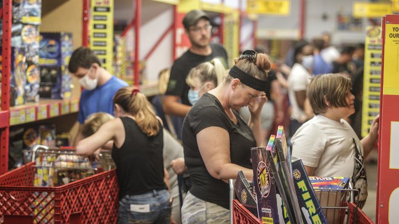 With Dayton canceling the annual Lights in Flight Fireworks Festival this weekend people packed the TNT Fireworks store on Union Road to make their own light show. Fireworks sales have been up lately according to fireworks shops. JIM NOELKER/STAFF