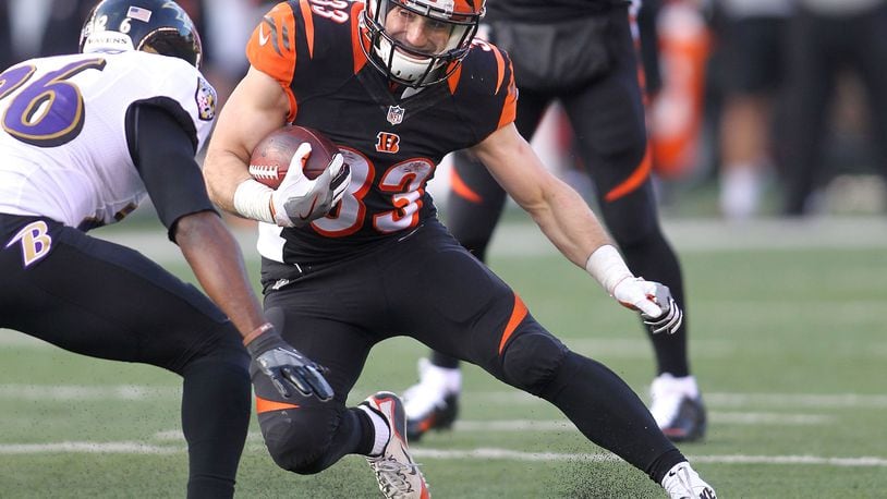 CINCINNATI, OH - JANUARY 1: Rex Burkhead #33 of the Cincinnati Bengals attempts to run the ball past Jerraud Powers #26 of the Baltimore Ravens during the second quarter at Paul Brown Stadium on January 1, 2017 in Cincinnati, Ohio. (Photo by John Grieshop/Getty Images)