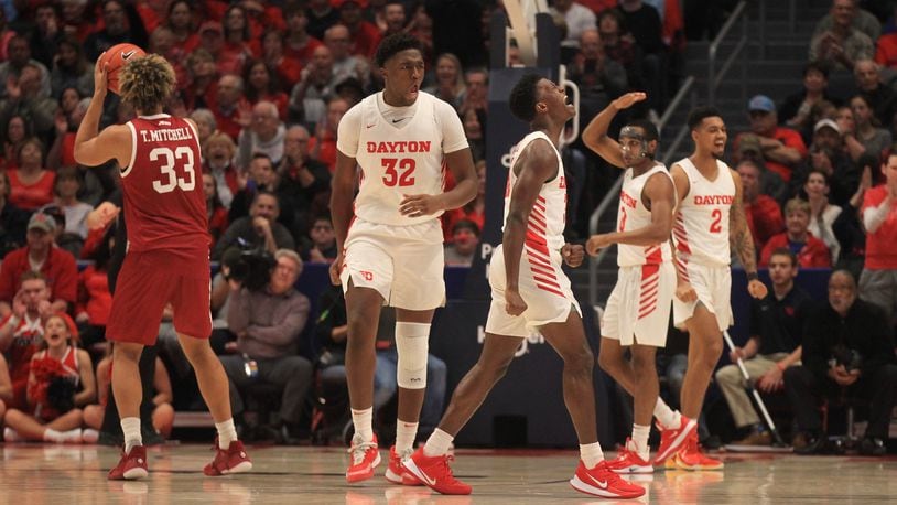 Dayton players react after a defensive stop against Massachusetts on Saturday, Jan. 11, 2020, at UD Arena. David Jablonski/Staff