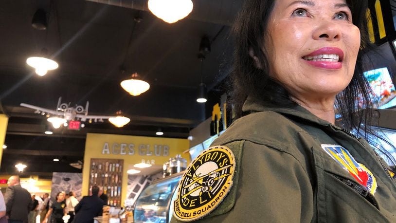 Sufong Lee wore a flight suit to the opening of the second Flyboy's location in downtown Dayton. Flyboy's moved into a space that had been vacant more than a decade. Lee is a close friend of the owners, Steve Crandall and Eunice Kim. CORNELIUS FROLIK / STAFF