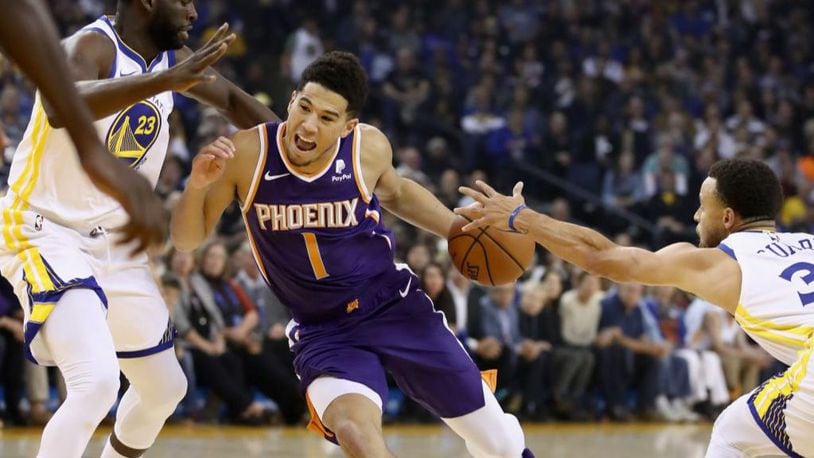 An Arizona boy will get to watch Devin Booker (1) and the Phoenix Suns on Wednesday for his first NBA game.