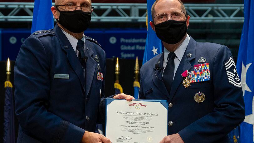 Gen. Arnold Bunch (left), commander of Air Force Materiel Command, presents the Legion of Merit to Chief Master Sgt. Stanley Cadell during the AFMC command chief’s retirement ceremony Oct. 1 in the National Museum of the U.S. Air Force. U.S. AIR FORCE PHOTO/R.J. ORIEZ